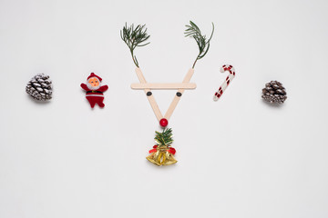 Christmas and New year background. Reindeer face made of Christmas decoration on white background. Creative flat lay, top view design.