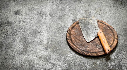 Serving background. Old hatchet on a chopping Board.