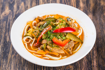 Close-up of traditional asian noodle lagman with vegetables and meat