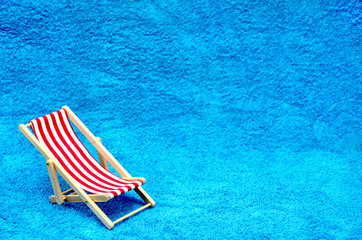 deck chair on a blue towel close up photo
