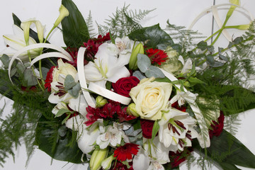 a red wedding flower bouquet in front of the car