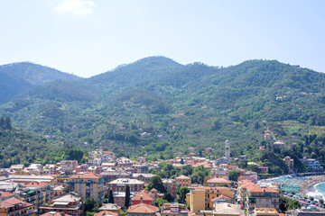 Fototapeta na wymiar Beautiful daylight view to green mountains and buildings of Levanto, Italy. Cinque Terre beauties