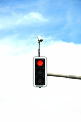 Traffic light with clouds in the background