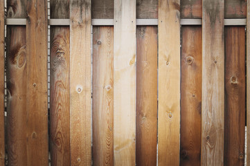 Fragment of a wooden brown modern fence close-up. Wood texture. Modern Style Design wooden Fence Ideas. Front view.