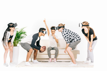 Naklejka premium multiethnic friends in virtual reality headsets