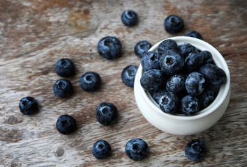 Blueberry on wooden table background.