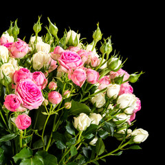 Bouquet of pink and white roses on a black background