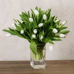 Bouquet of white tulips in a glass vase
