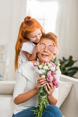 daughter covering mothers eyes