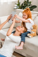 mother and daughter using tablet together