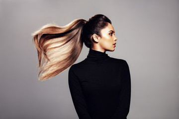 Stylish young woman with flying hair