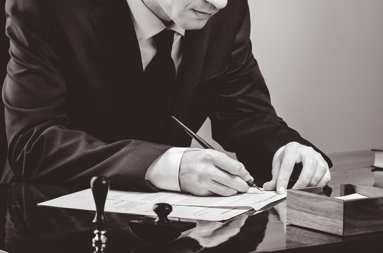 Signing contract. Lawyer or notar on his workplace