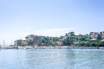 Naklejka na ściany i meble Daylight view to mountains, blue sea, beach pier and city of Rapallo, Italy.