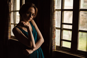 Fototapeta premium Pretty young women waiting by the window