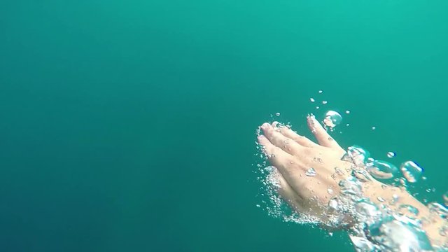 Man swims freestyle in the sea, slow motion