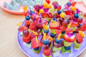 Closeup of skewers with various fruits berries