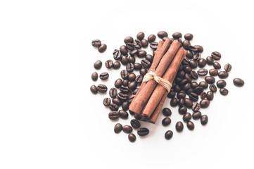 Coffee beans and sticks of cinnamon on the white isolated background. Natural energy drink.