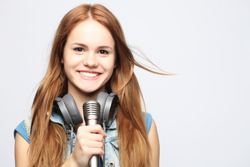 young girl with microphone sings