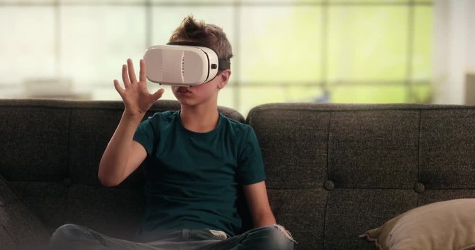 Boy using virtual reality headset on the couch