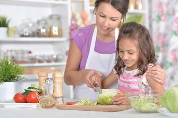 Mother and daughter preparing dinner