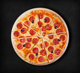 Pepperoni pizza on a black background. Visit my page. You will be able to find an image for every pizza sold in your cafe or restaurant 