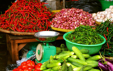 chili pepper, cucumbers, beans, garlic and scales on the street market