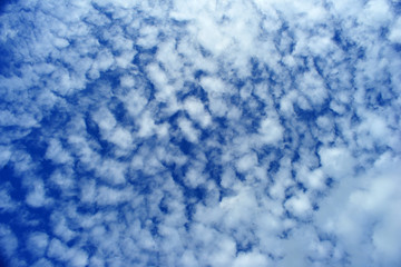 White fluffy clouds on blue sky for background.