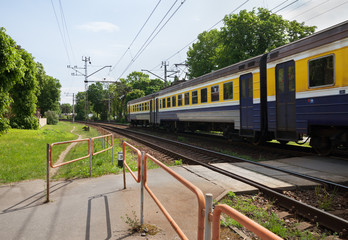 Naklejka premium Train passing a railway crossing.