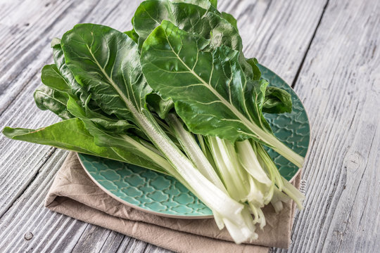 Fresh organic chard on a rustic background