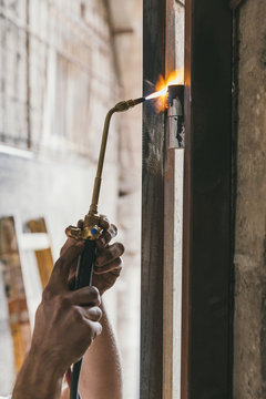 Closeup of hands using brazing machine with oxyacetylene