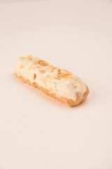 Close up of white eclair with nuts