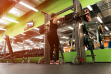 Blurred picture of exercising female in gym