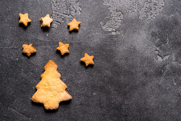 Christmas tree and stars cookies on grey background