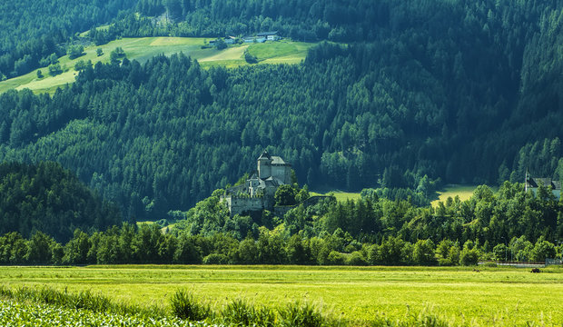 Background landscape view of aAncient castle among the fields in Tyrol, Austria