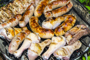 Obraz na płótnie Canvas Sausages pork ribs chicken legs on the grill barbecue