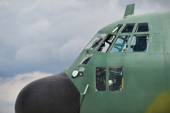 Military Hercules airplane on the runway - Powered by Adobe