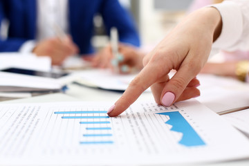 Fototapeta premium Female arm point pinger in financial graph