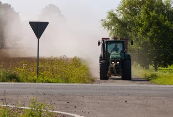 Tuinposter Big tractor on crossroad. © Ludmila Smite