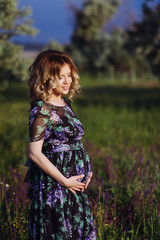 Beautiful pregnant woman on a walk in nature