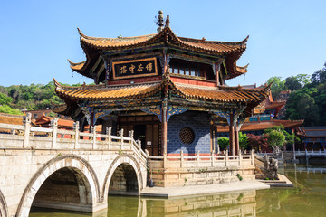 Traditional Chinese Buddhist Confucius temple with a stone bridge and pond