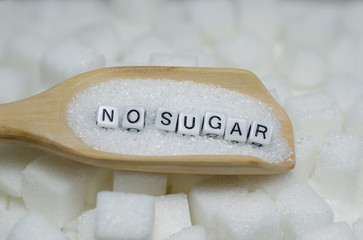 The letters "NO SUGAR" on wooden spoon