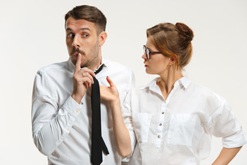 The business man and woman communicating on a gray background