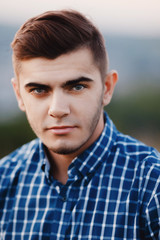 Fototapeta premium Portrait of a man close-up hipster with beard, sideburns, beard and styling, dark hair.