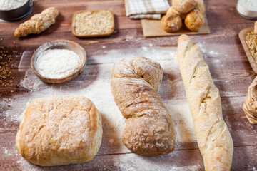 Freshly baked delicious bread on a rustic wooden table, healthy eating concept