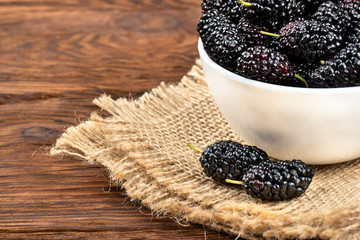 Fototapeta na wymiar Black mulberries in bowl