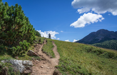 Fototapeta na wymiar traveler trekking to low peak of White Peak in Dolomites mountain, South Tyrol, Italy.