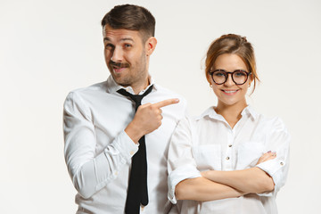 The business man and woman communicating on a gray background