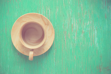 Coffee cup on rustic wood background.