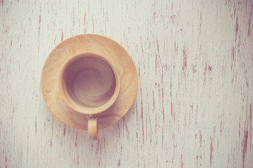Coffee cup on rustic wood background.