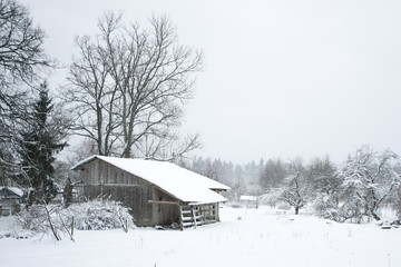 Winter countryside view of old wood house.